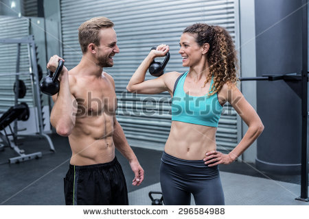 stock-photo-muscular-couple-discussing-together-while-lifting-kettlebells-296584988